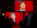 Video screens show Prime Minister Justin Trudeau as he delivers a speech at the federal Liberal national convention in Halifax on April 21, 2018.