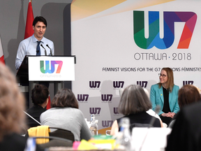 Oxfam Canada executive director Julie Delahanty and delegates listen as Prime Minister Justin Trudeau speaks at the W7: Feminist Visions for the G7 meeting in Ottawa on April 25, 2018.