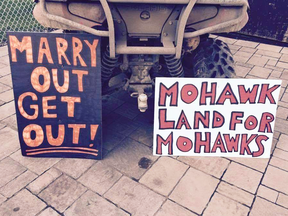 Signs placed at a Kahnawake family's property in 2015, after the stayed past a deadline set for them to  for them to leave.