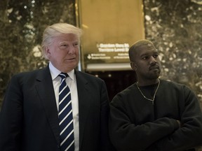 Donald Trump and Kanye stand together in the lobby at Trump Tower, December 13, 2016 in New York City.