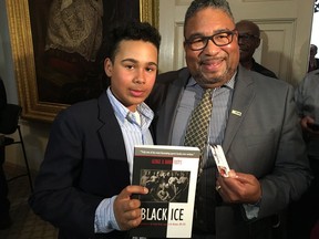12-year-old Mark Connors, left, and African Nova Scotian Affairs Minister Tony Ince pose for a photo at the Nova Scotia Legislature in Halifax on Tuesday, April 17, 2018. The Nova Scotia Legislature played host Tuesday to a 12-year-old hockey goalie who was recently the victim of a racial slur on the ice. Tony Ince, the Minister of African Nova Scotian Affairs, says it was important to show support for Mark Connors because all Nova Scotians should feel respected and should have a sense of dignity and comfort, "no matter where they go." Ince says he told the peewee player that he should "keep his chin up" and that all Nova Scotians support him.