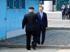 South Korean President Moon Jae-in, right, and North Korean leader Kim Jong Un meet at the concrete strip that marks the border between the two countries, April 27, 2018.