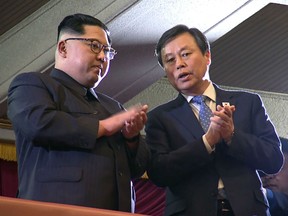 Short pool TV footage showed Kim, clad in a dark Mao-style suit, clapping from the second-floor VIP stand as South Korean Culture Minister Do Jong-hwan bowed and greeted North Korean spectators looking on from the first floor.