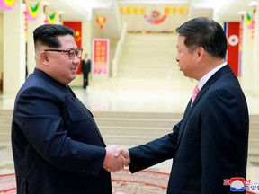 In this April 14, 2018, photo provided Sunday, April 15, 2018, by the North Korean government, North Korean leader Kim Jong Un, left, shakes hands with Song Tao, head of the Chinese Communist Party Central Committee's international department in North Korea. North Korean leader Kim met the high-ranking Chinese diplomat, amid a flurry of diplomacy following Kim's surprise visit to Beijing. Independent journalists were not given access to cover the event depicted in this image distributed by the North Korean government. The content of this image is as provided and cannot be independently verified. Korean language watermark on image as provided by source reads: "KCNA" which is the abbreviation for Korean Central News Agency. (Korean Central News Agency/Korea News Service via AP)