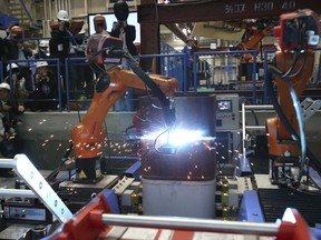 Shimizu Corp.'s Robo-Welder is demonstrated during a press tour to the major Japanese construction company's robot laboratory in Tokyo, Monday, April 23, 2018. The Robo-Welder has a robotic arm that uses laser shape measurement to determine the contours of a groove, or channel, on a steel column to be welded. Shimizu showed several robots that can weld and bolt, being developed for construction sites for safety for workers.