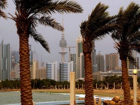 FILE- In this April 16, 2009 file photo, the Kuwait city skyline is seen through the haze of a sand storm in Shuwaikh, Kuwait City. Kuwait on Wednesday, April 25, 2018,  gave a one-week deadline for the Philippines ambassador to leave the small, oil-rich Gulf Arab nation over a growing diplomatic dispute regarding the abuse of Filipina housemaids and workers in the country. (AP Photo, File)