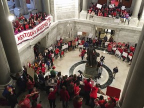 Hundreds of Kentucky teachers protest outside of Gov. Matt Bevin's office on Friday, March 30, 2018, in Frankfort, Ky. State lawmakers passed a bill late Thursday night that makes changes to the state's pension system. Bevin could sign the bill into law on Friday.