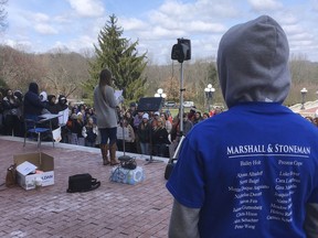 In this March 20, 2018 photo, a Marshall County High School student wears a shirt with the victims of 2018 school shootings in Kentucky and Florida during a rally in Frankfort, Ky. Some students from Marshall County have been inspired by Florida students who have spoken out about gun control, but new gun laws are a hard sell in rural Kentucky.