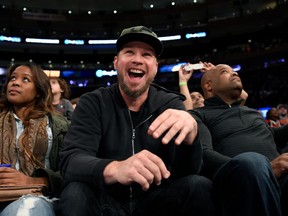 FILE - In this Nov. 6, 2016 file photo, Pearl Jam bassist Jeff Ament reacts as he is introduced during an NBA basketball game between the New York Knicks and the Utah Jazz in New York. One of the four cities in Pearl Jam's North American tour this summer will be tiny Missoula, Mont., Ament's part-time home. The pioneering grunge rock band plays the venue each time Ament's hometown friend, U.S. Sen. Jon Tester, is up for election, and this time the band plans to give some of the proceeds of the show to four groups that support youth and Native American voting, land conservation and women's health.