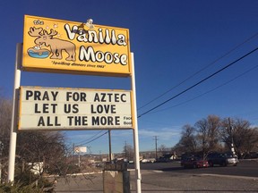 FILE - In this Dec. 8, 2017, file photo, a sign encourages prayer outside an ice cream shop in Aztec, N.M., following a shooting at Aztec High School in which two classmates were killed before the gunman killed himself. Residents of the rural New Mexico town have worked hard to define a new normal following the December school shooting. But they say the healing process is far from over.