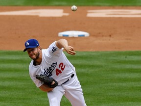 Los Angeles Dodgers starting pitcher Clayton Kershaw throws to the plate during the second inning of a baseball game against the Arizona Diamondbacks, Sunday, April 15, 2018, in Los Angeles. Players wore No. 42 jerseys to commemorate Jackie Robinson Day.