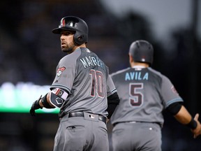 Arizona Diamondbacks' Deven Marrero, left, looks back toward the first base coach as Alex Avila runs in front of him after Marrero hit what was initially a three-run home run during the fourth inning of a baseball game against the Los Angeles Dodgers, Saturday, April 14, 2018, in Los Angeles. Following a review, Marrero was called out for passing Avila.