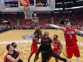 Portland Trail Blazers guard Damian Lillard (0) goes to the basket against New Orleans Pelicans forward Nikola Mirotic (3) during the first half of Game 3 of a first-round NBA basketball playoff series in New Orleans, Thursday, April 19, 2018.