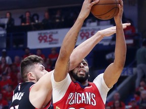 New Orleans Pelicans forward Anthony Davis (23) is fouled by Portland Trail Blazers center Jusuf Nurkic (27) as he drives to the basket during the first half of Game 4 of a first-round NBA basketball playoff series in New Orleans, Saturday, April 21, 2018.