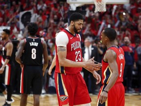 New Orleans Pelicans forward Anthony Davis (23) celebrates with guard Rajon Rondo (9) after defeating the Portland Trail Blazers in Game 4 of a first-round NBA basketball playoff series in New Orleans, Saturday, April 21, 2018.