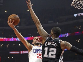 San Antonio Spurs forward LaMarcus Aldridge (12) blocks the shot attempt of Los Angeles Clippers guard Austin Rivers (25) during the first half of an NBA basketball game in Los Angeles on Tuesday, April 3, 2018.