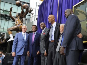 Lakers greats pose after the unveiling of a statue of Minneapolis and Los Angeles Lakers player Elgin Baylor, second from left, outside Staples Center in Los Angeles Friday, April 6, 2018. From left are Jerry West, Baylor, Earvin "Magic" Johnson, Kareem Abdul-Jabbar, musician Bill Withers, and Shaquille O'Neal.