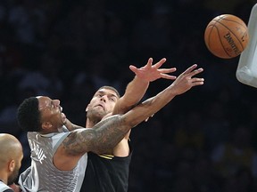 Minnesota Timberwolves guard Jeff Teague (0) shoots as Los Angeles Lakers center Brook Lopez (11) defends during the first half of an NBA basketball game in Los Angeles on Friday, April 6, 2018.