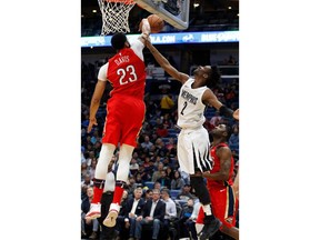 New Orleans Pelicans forward Anthony Davis (23) blocks a shot by Memphis Grizzlies guard Kobi Simmons (2) during the first half of an NBA basketball game in New Orleans, Wednesday, April 4, 2018.