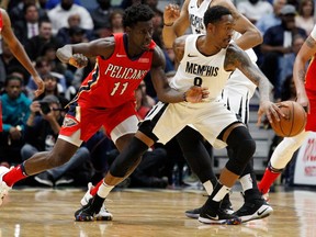 Memphis Grizzlies guard MarShon Brooks (8) keeps the ball from New Orleans Pelicans guard Jrue Holiday (11) during the second half of an NBA basketball game in New Orleans, Wednesday, April 4, 2018. The Pelicans won 123-95.