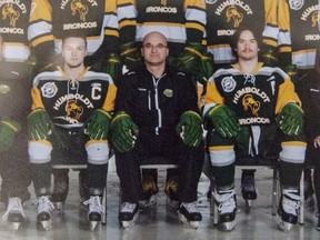 Head coach and general manager Darcy Haugan, centre, is shown in team photo of the 2016/2017 Humboldt Broncos hockey team as it hangs in Elgar Petersen Arena in Humboldt, Sask., on Saturday, April 7, 2018. The head coach of the Humboldt Broncos hockey team is among 14 dead following a horrific bus crash in Saskatchewan. Darcy Haugan was on the junior hockey team's bus Friday on the way to a playoff game in northeastern Saskatchewan when it collided with a truck.