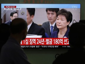 In this April 6, 2018 photo, people watch a TV screen showing file footage of former South Korean President Park Geun-hye during a news program at the Seoul Railway Station in Seoul, South Korea. North Korea has called disgraced former South Korean President Park Geun-hye a "traitor" responsible for "extra-large hideous corruption," in its first reaction to the sentencing of Park to 24 years in prison on corruption charges.