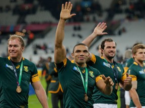 FILE - In this Friday, Oct. 30, 2015 file photo, South Africa's Bryan Habana, center, and teammates wave after receiving their medals after winning their bronze medal Rugby World Cup match against South Africa at the Olympic Stadium, London. Bryan Habana, the lightning-fast South Africa wing who won a World Cup on the way to breaking his country's all-time try-scoring record, says he is retiring. Habana, who played 124 tests for the Springboks and scored a record 67 tries, made the announcement on his Twitter and Instagram accounts on Tuesday, April 24, 2018.