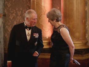 Britain's Prince Charles speaks to Britain's Prime Minister Theresa May before taking part in a receiving line at the Queen's Dinner for the Commonwealth Heads of Government Meeting (CHOGM) at Buckingham Palace in London, Thursday, April 19, 2018.