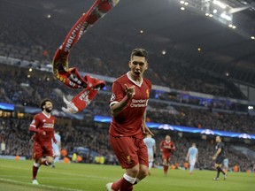 Liverpool's Roberto Firmino celebrates scoring his side's second goal during the Champions League quarterfinal second leg soccer match between Manchester City and Liverpool at Etihad stadium in Manchester, England, Tuesday, April 10, 2018.