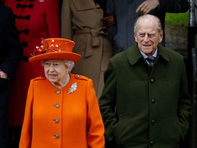 In this file photo dated Monday, Dec. 25, 2017, Britain's Queen Elizabeth II and Prince Philip, wait for their car following the traditional Christmas Day church service, at St. Mary Magdalene Church in Sandringham, England.