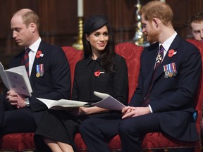 Britain's Prince William, left, Prince Harry and Meghan Markle attend a Service of Thanksgiving and Commemoration on ANZAC Day at Westminster Abbey in London, Wednesday, April 25, 2018.