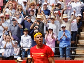 FILE - In this Sunday, April 8, 2018 file photo Spain's Rafael Nadal reacts after defeating Germany's Alexander Zverev 6-1, 6-4, 6-4 during a World Group Quarter final Davis Cup tennis match between Spain and Germany at the bullring in Valencia, Spain. For now, Nadal doesn't see himself skipping Wimbledon the way Roger Federer has the French Open.  The two veterans are back at the top of world tennis, with Nadal needing to win this week's Monte Carlo Masters to avoid losing his top ranking once again to Federer in their seemingly eternal battle for tennis supremacy.