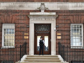 A police officers stands outside the Lindo Wing of St Mary's Hospital in Paddington, London, Monday April 23, 2018. Kate, the Duchess of Cambridge entered a London hospital Monday in labor with a baby who will be a third child for her and husband Prince William and fifth in line to the throne, Britain's royal palace said.