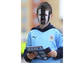 A young Newcastle United fan wears facepaint ahead of the English Premier League soccer match between Leicester City and Newcastle at the King Power stadium, Leicester, England. Saturday, April 7, 2018