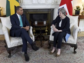 Britain's Prime Minister Theresa May and Prime Minister of Jamaica Andrew Holness speak during a bilateral meeting at 10 Downing Street, London, Tuesday April 17, 2018.