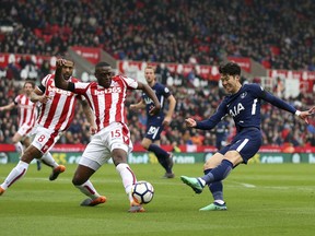 Tottenham Hotspur's Son Heung-Min shoots as Stoke City's Bruno Martins Indi attempts to block during the English Premier League soccer match between Stoke City and Tottenham Hotspur at the bet365 Stadium Stoke, England. Saturday, April 7, 2018, 2018.
