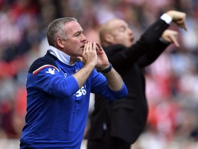 Stoke City manager Paul Lambert gestures on the touchline during the English Premier League soccer match against Burnley at the bet365 Stadium, Stoke, England, Sunday April 22, 2018.