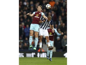 Burnley's James Tarkowski, left, and West Bromwich Albion's Salomon Rondon jump for a high ball during the English Premier League soccer match at The Hawthorns in West Bromwich, England, Saturday March 31, 2018.