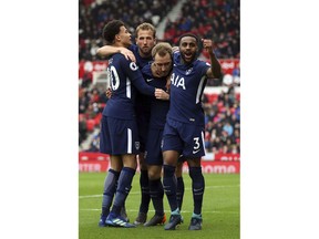 Tottenham Hotspur's Christian Eriksen, center, celebrates scoring his side's first goal of the game with his team-mates during the English Premier League soccer match between Stoke City and Tottenham Hotspur at the bet365 Stadium Stoke, England. Saturday, April 7, 2018, 2018.