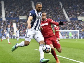 West Bromwich Albion's Matt Phillips, left, is tackled by Swansea's Martin Olsson during their English Premier League soccer match between West Bromwich Albion and Swansea City at the Hawthorns, West Bromwich, England. Saturday, April 7, 2018.