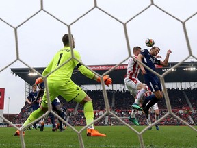 FILE - In this Saturday, April 7, 2018, file photo, Tottenham Hotspur's Harry Kane, right, attempts to get a touch on his side's second goal scored by teammate Christian Eriksen during the English Premier League soccer match against Stoke City in, England. Kane appealed to the FA that he had the final touch on the ball before it went in. On Wednesday, April 12, the league agreed and awarded the goal to Kane.