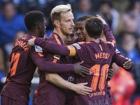 Barcelona's Philippe Coutinho, background center, is congratulated by teammates after scoring a goal during a Spanish La Liga soccer match between Deportivo and Barcelona at the Riazor stadium in A Coruna, Spain, Sunday, April 29, 2018.