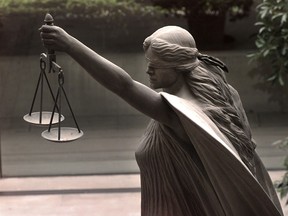 A statue of Justice stands outside the law courts in Vancouver, B.C.