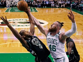 Boston Celtics center Aron Baynes (46) battles for a rebound against Milwaukee Bucks forward Khris Middleton, left, during the first quarter of Game 2 of an NBA basketball first-round playoff series in Boston, Tuesday, April 17, 2018.