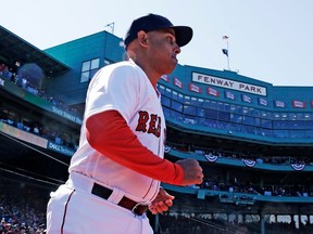 Boston Red Sox manager Alex Cora runs onto the field as he is introduced during ceremonies prior to a home opener baseball game against the Tampa Bay Rays at Fenway Park in Boston, Thursday, April 5, 2018.