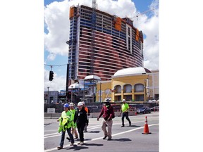 Construction workers leave at the end of their shift at the Wynn Resorts casino site in Everett, Mass., Thursday, April 26, 2018. Massachusetts gambling regulators consider Wynn Resorts' request to remove the name of company founder Steve Wynn, who faces numerous allegations of sexual misconduct, from its state casino license.