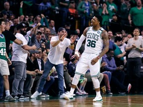 Boston Celtics guard Marcus Smart (36) celebrates a basket with fans during the second quarter of Game 7 of an NBA basketball first-round playoff series against the Milwaukee Bucks in Boston, Saturday, April 28, 2018.
