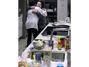 In this Thursday, March 15, 2018, photo, registered dietician Tracey Burg, the head chef of The Teaching Kitchen, left, is embraced by patient Cheryl Facey, of the South End neighborhood of Boston, after a "Cooking for Recovery" class at the Boston Medical Center in Boston. The hospital offers the class to patients in recovery as part of a growing trend toward taking a more comprehensive approach to treating addiction.