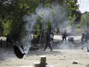 Victims in double explosions lie on the ground in Kabul, Afghanistan, Monday, April 30, 2018.