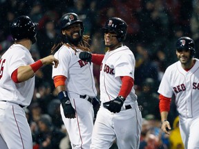 Boston Red Sox's Xander Bogaerts, center, celebrates his grand slam that also drove in, from left to right, Mitch Moreland, Hanley Ramirez and J.D. Martinez during the third inning of a baseball game against the Kansas City Royals in Boston, Monday, April 30, 2018.